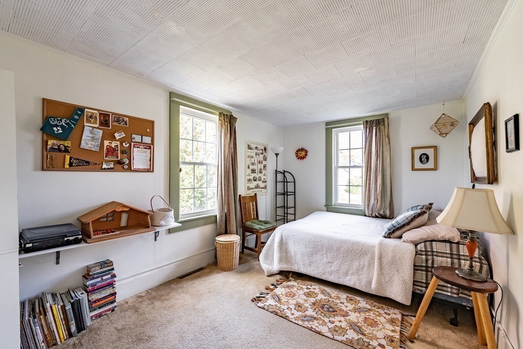 65 Old Bay Road Belchertown, MA 01007 - Photo 19 of 42 a bedroom with a bed a couch and a window