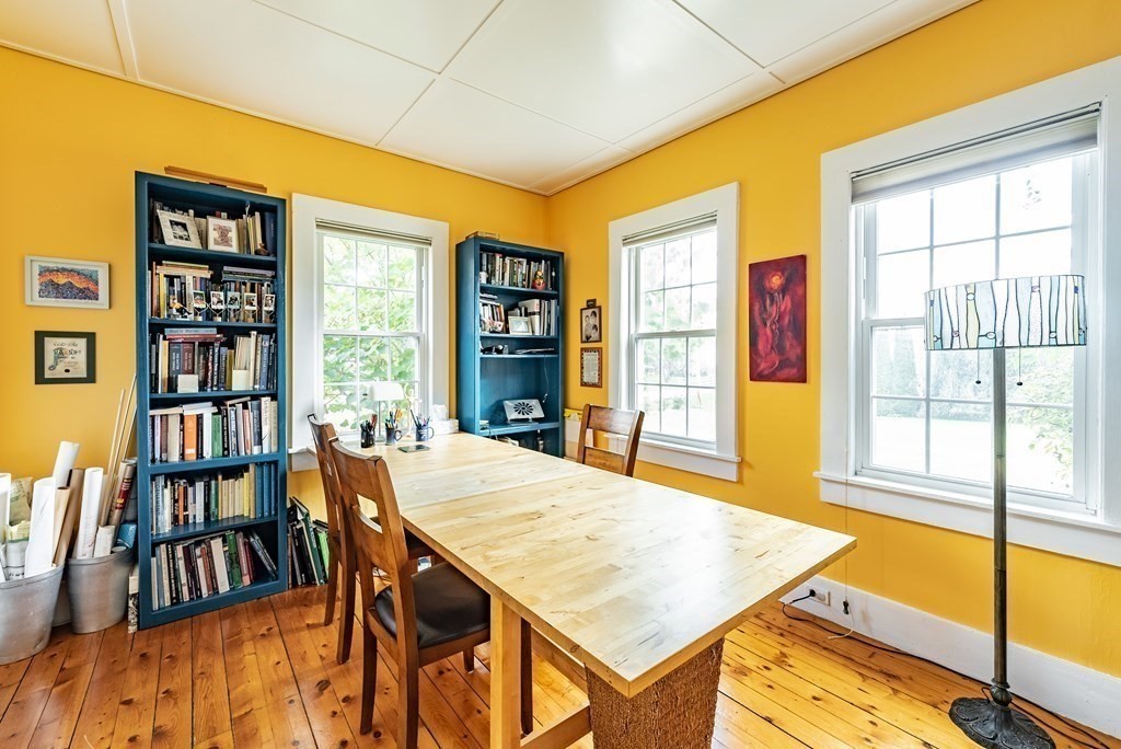 65 Old Bay Road Belchertown, MA 01007 - Photo 23 of 42 a living room with a table chairs and a book shelf
