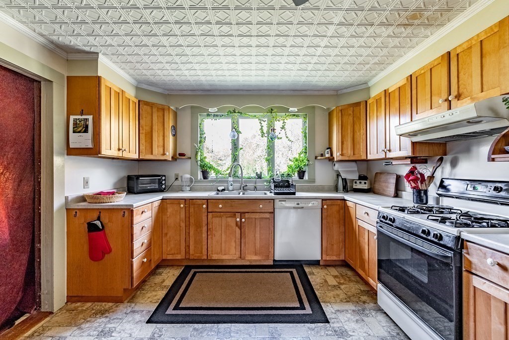 65 Old Bay Road Belchertown, MA 01007 - Photo 10 of 42 a kitchen with stainless steel appliances granite countertop a stove a sink dishwasher and cabinets with wooden floor