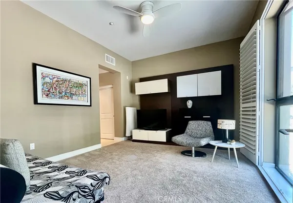 a bedroom with bed and a chair