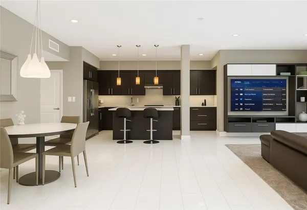 a living room with furniture a fireplace and a kitchen view