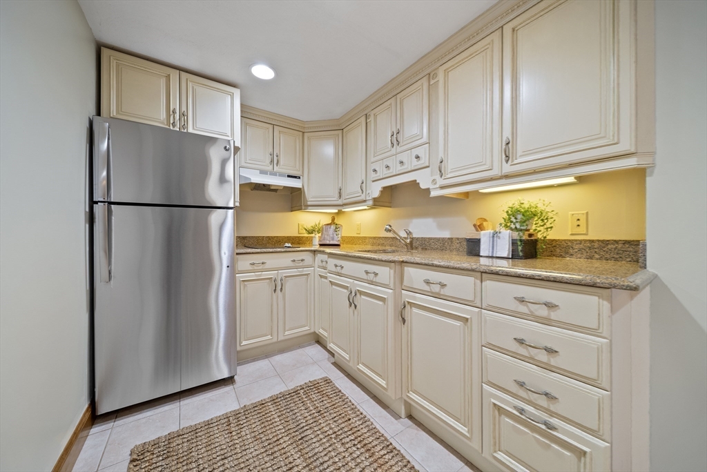 21 Cranberry Road Pepperell, MA 01463 - Photo 18 of 41 a kitchen with granite countertop cabinets and refrigerator