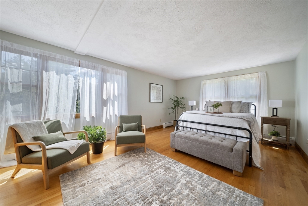 21 Cranberry Road Pepperell, MA 01463 - Photo 26 of 41 a spacious bedroom with a bed and a couch