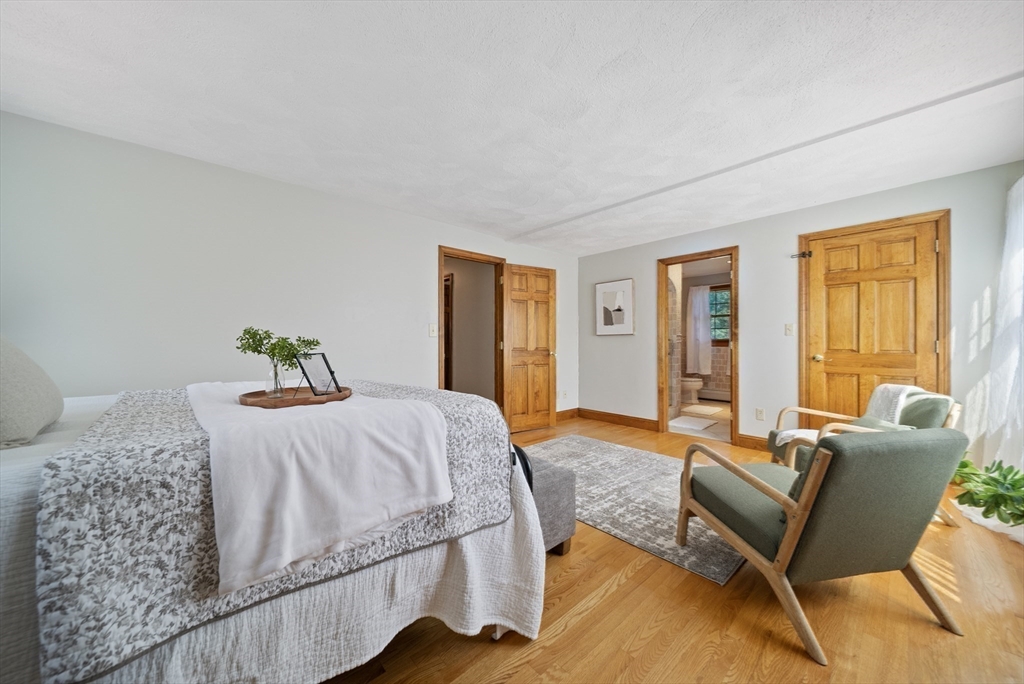 21 Cranberry Road Pepperell, MA 01463 - Photo 27 of 41 a bedroom with a bed and wooden floor