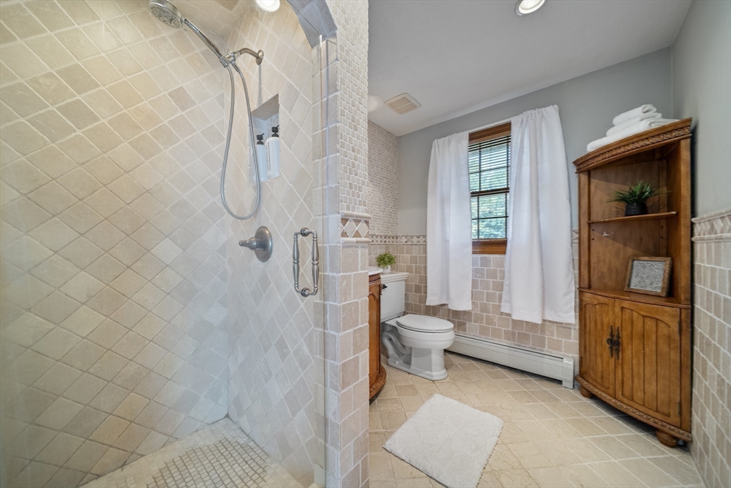 21 Cranberry Road Pepperell, MA 01463 - Photo 28 of 41 a bathroom with a granite countertop shower and a toilet