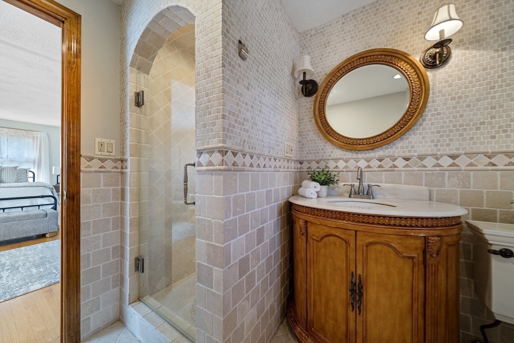 21 Cranberry Road Pepperell, MA 01463 - Photo 29 of 41 a bathroom with a sink a mirror and a shower