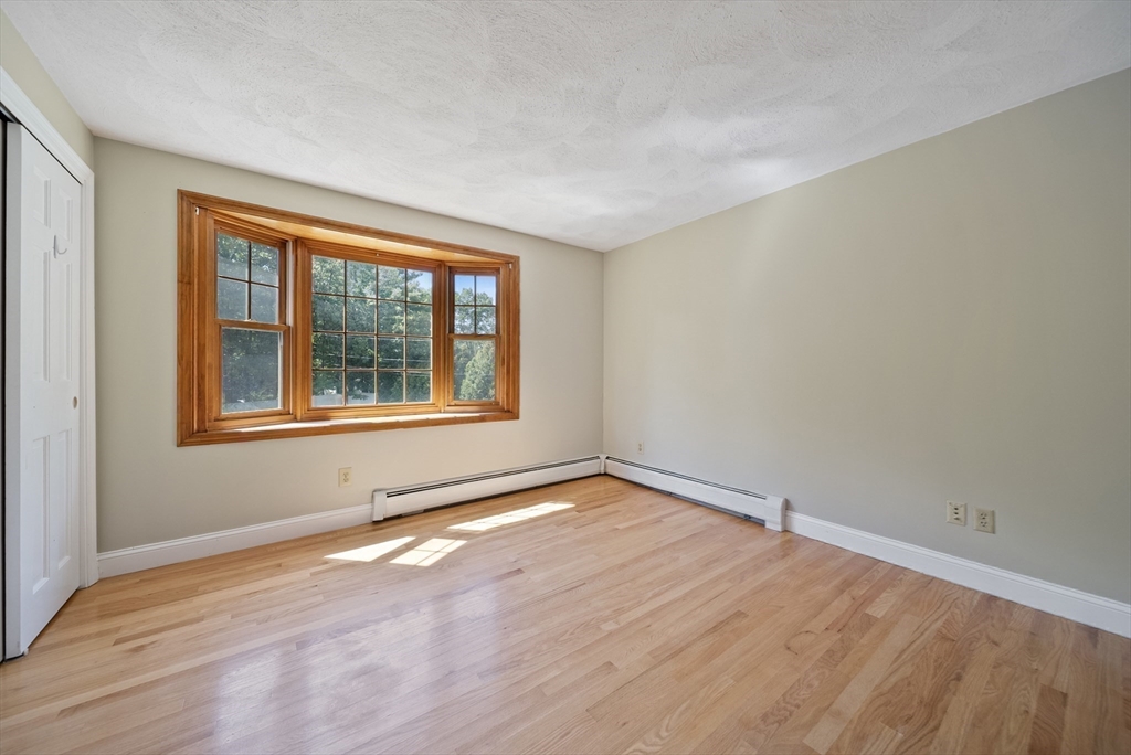 21 Cranberry Road Pepperell, MA 01463 - Photo 31 of 41 a view of an empty room with wooden floor and a window