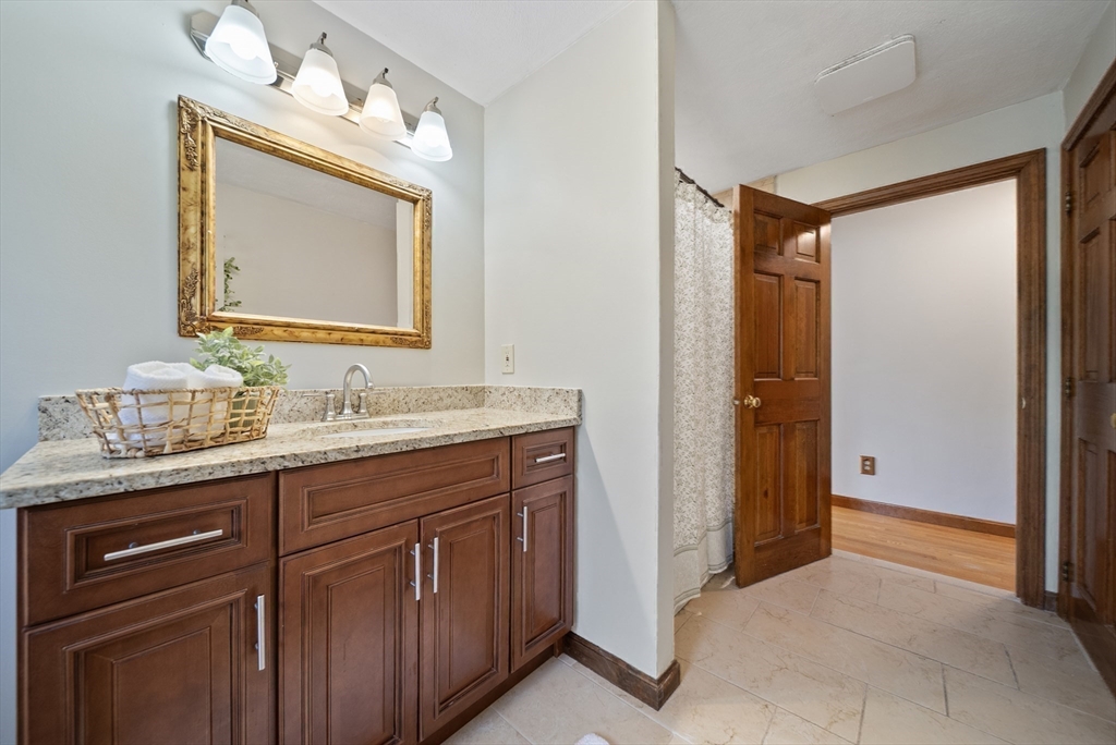 21 Cranberry Road Pepperell, MA 01463 - Photo 33 of 41 a bathroom with a granite countertop sink vanity and mirror