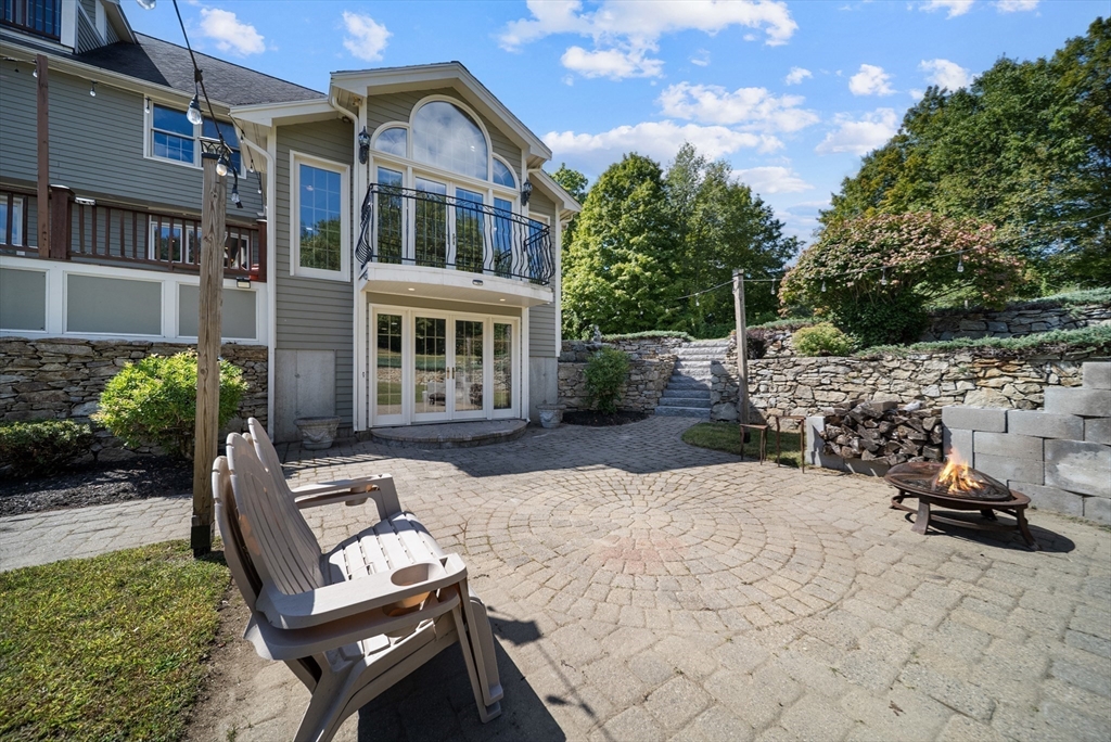 21 Cranberry Road Pepperell, MA 01463 - Photo 38 of 41 a view of a patio with chair and tables back yard of the house