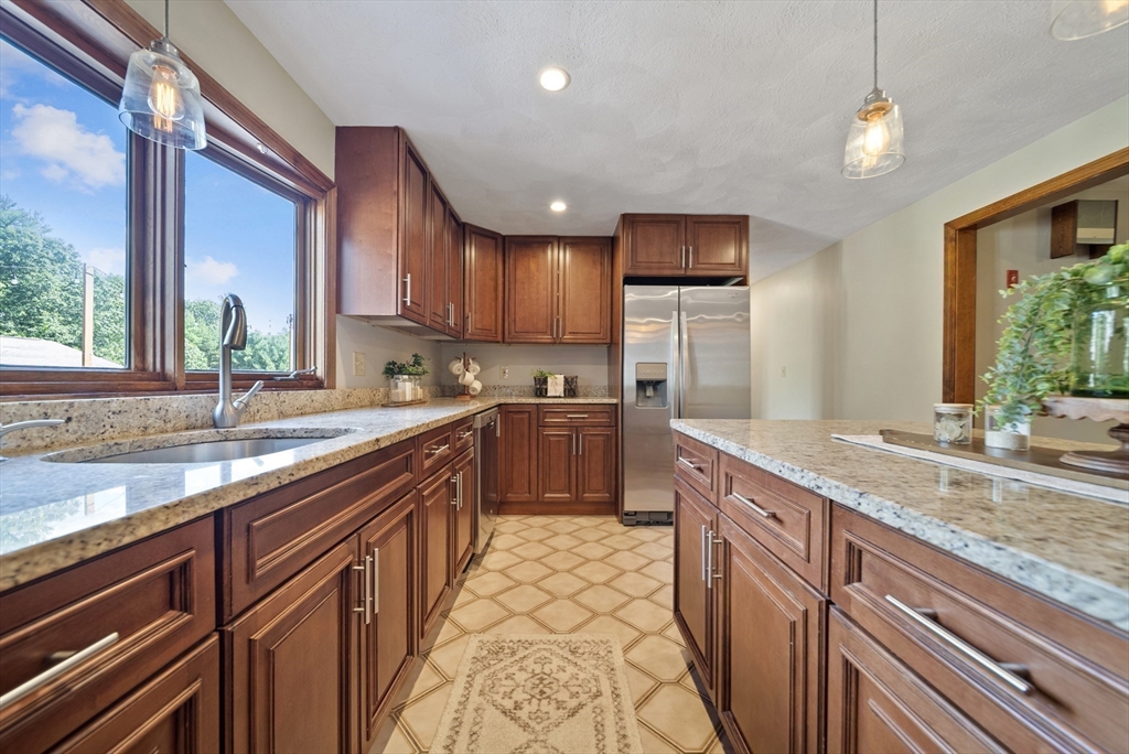 21 Cranberry Road Pepperell, MA 01463 - Photo 6 of 41 a kitchen with stainless steel appliances granite countertop a sink stove and cabinets