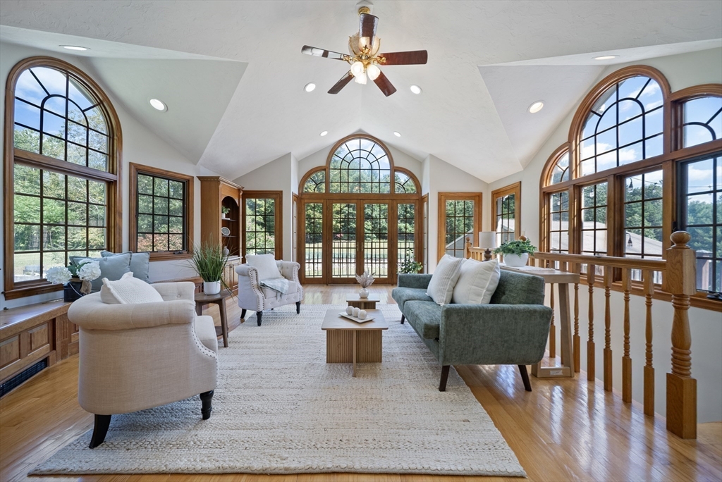 21 Cranberry Road Pepperell, MA 01463 - Photo 8 of 41 a living room with furniture a fireplace and a chandelier