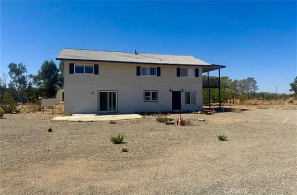a backyard of a house with yard and garage