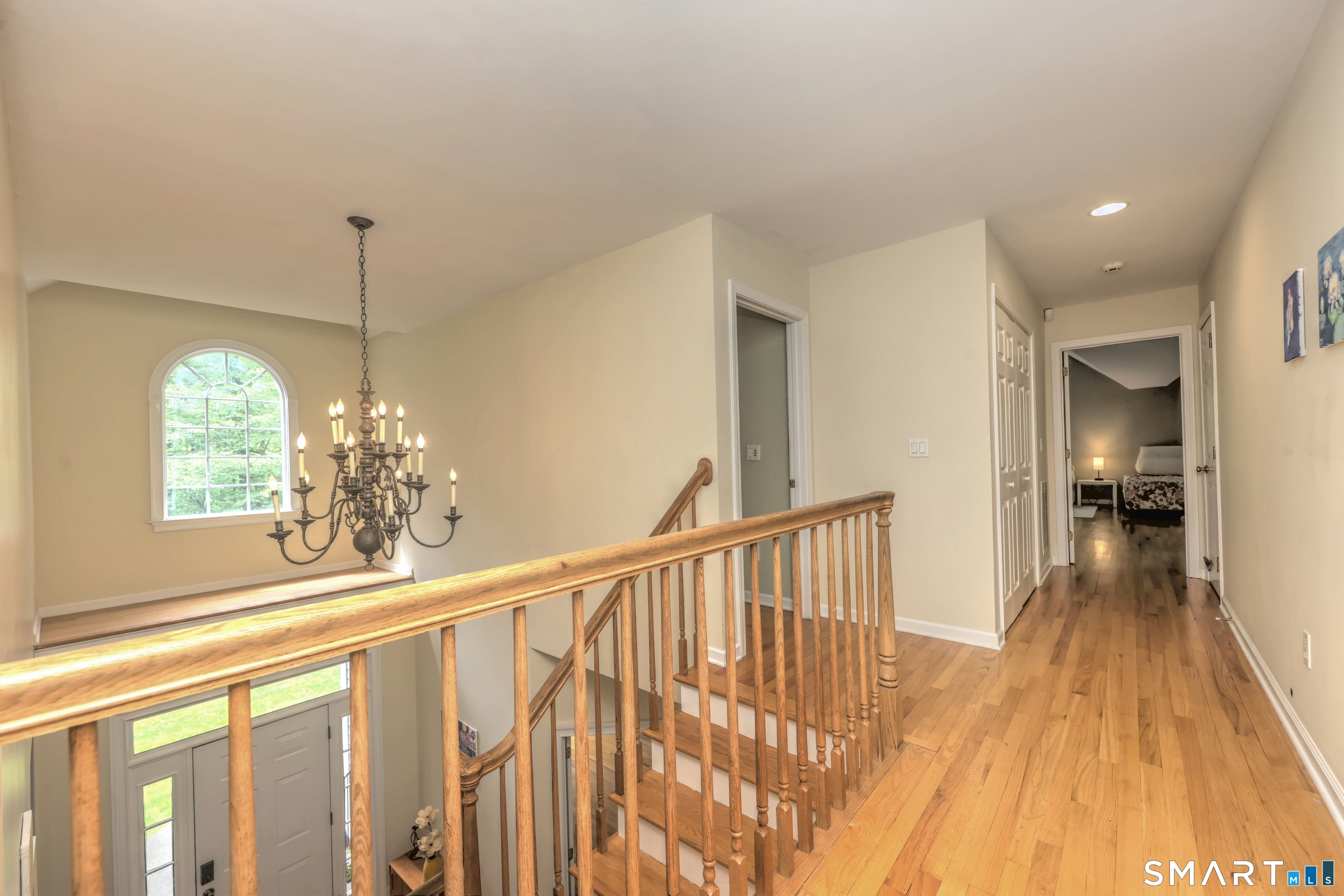 125 Peck Hill Road Woodbridge, CT 06525 - Photo 18 of 40 a view of a hallway with wooden floor and staircase