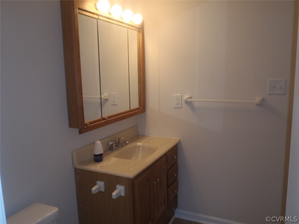 3219 Brookforest Road Midlothian, VA 23112 - Photo 14 of 23 a bathroom with a sink and a mirror