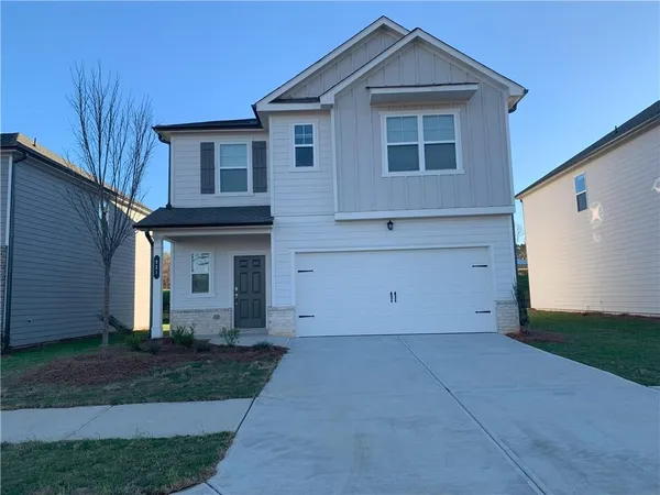a view of house with backyard