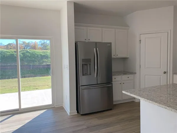 a kitchen with stainless steel appliances granite countertop a refrigerator and a sink