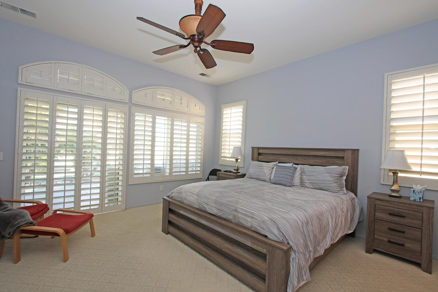82652 Sky View Lane Indio, CA 92201 - Photo 20 of 44 a bedroom with a bed a chandelier and a couch