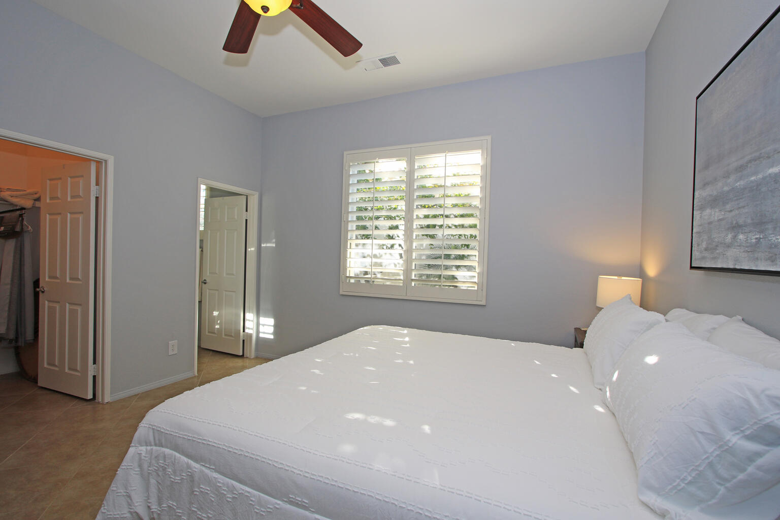 82652 Sky View Lane Indio, CA 92201 - Photo 27 of 44 a bedroom with a bed and a chandelier