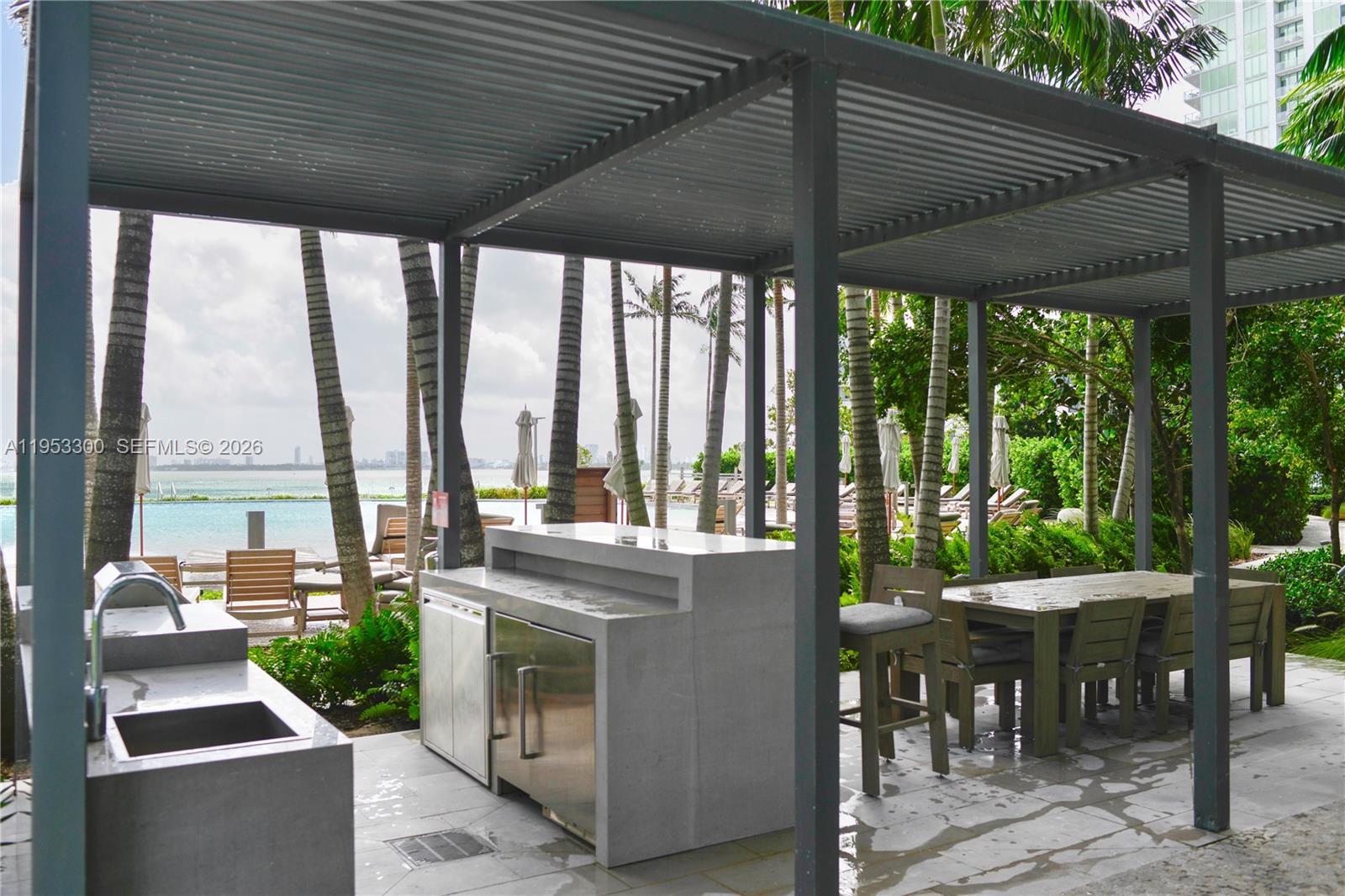 650 Northeast 32nd Street, Unit 2703 Miami, FL 33137 - Photo 25 of 51 a patio with a patio table and chairs