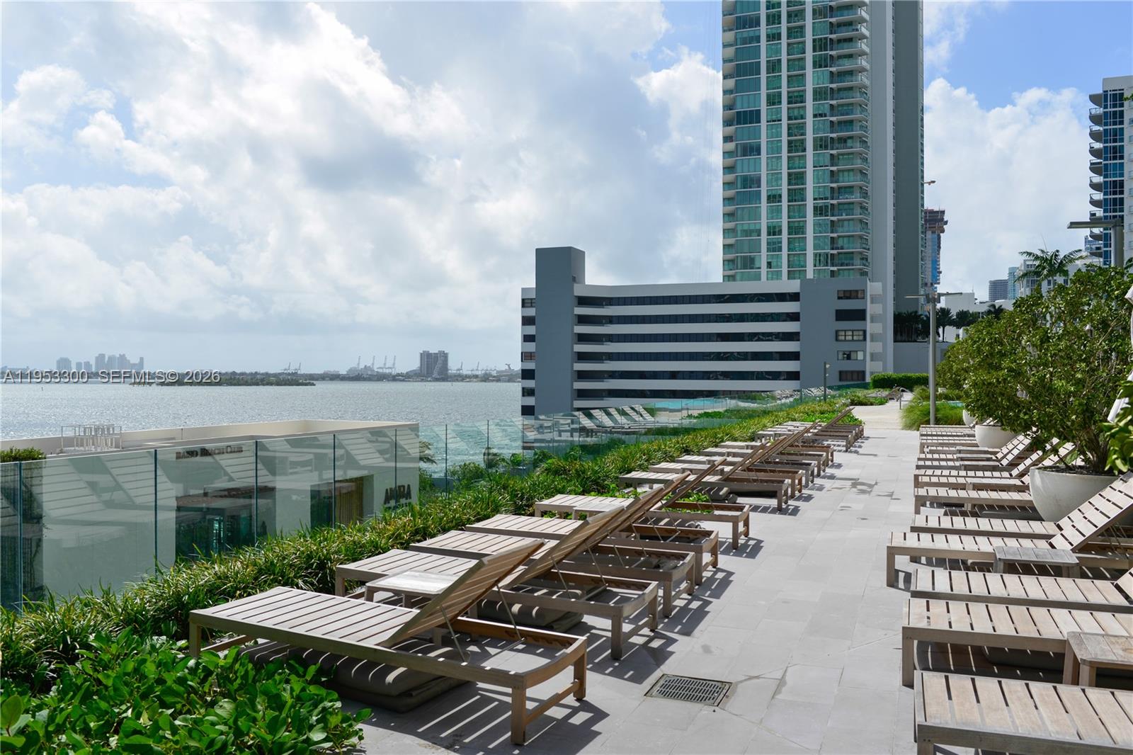 650 Northeast 32nd Street, Unit 2703 Miami, FL 33137 - Photo 30 of 51 a view of a patio with a table and chairs and potted plants