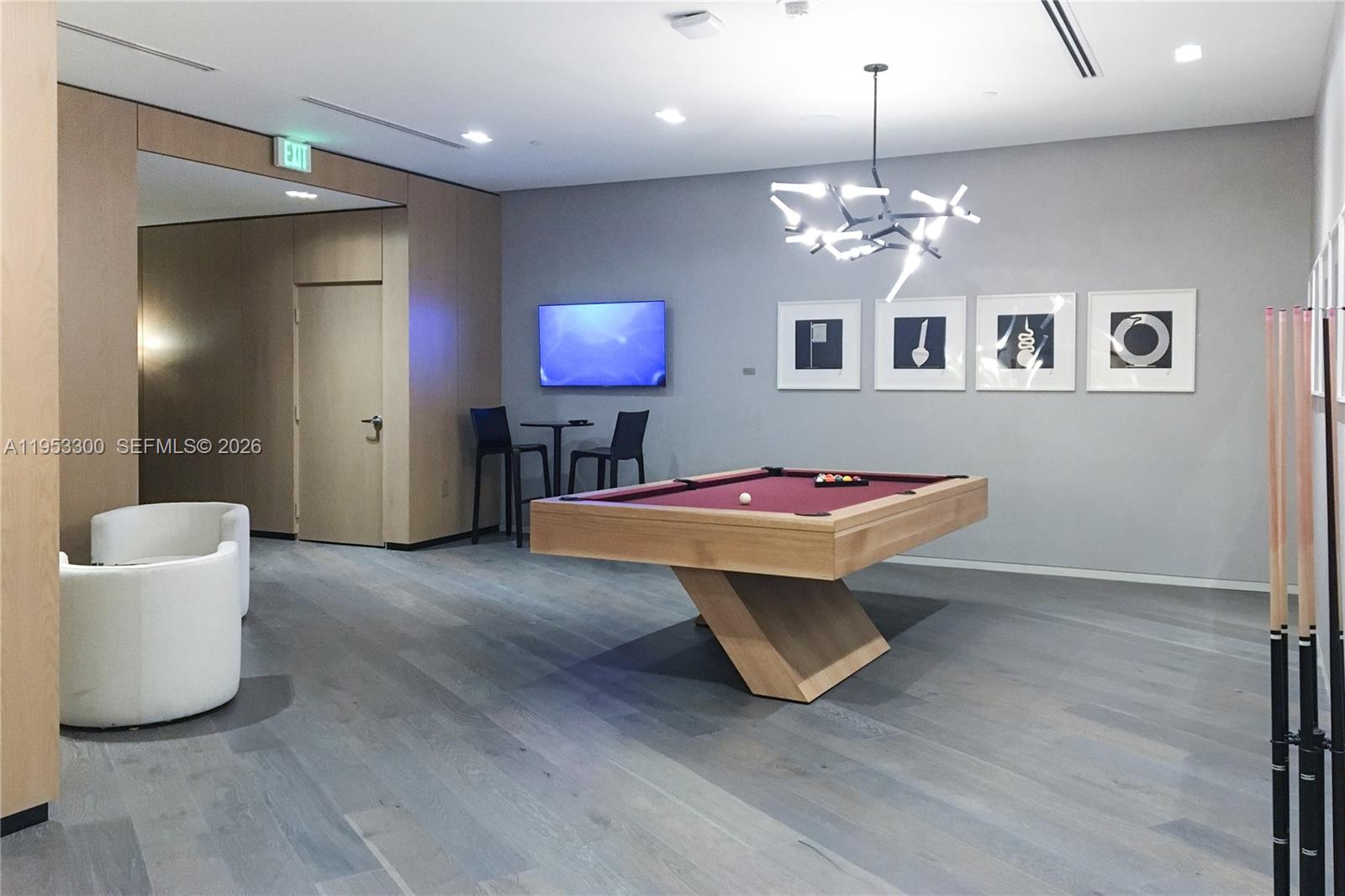 650 Northeast 32nd Street, Unit 2703 Miami, FL 33137 - Photo 36 of 51 a room with table chairs piano and wooden floor