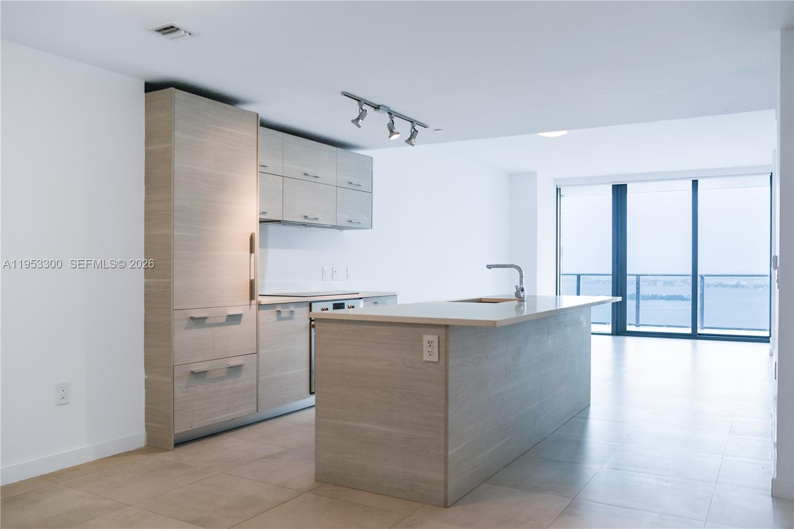 650 Northeast 32nd Street, Unit 2703 Miami, FL 33137 - Photo 42 of 51 a kitchen with a sink stainless steel appliances and cabinets