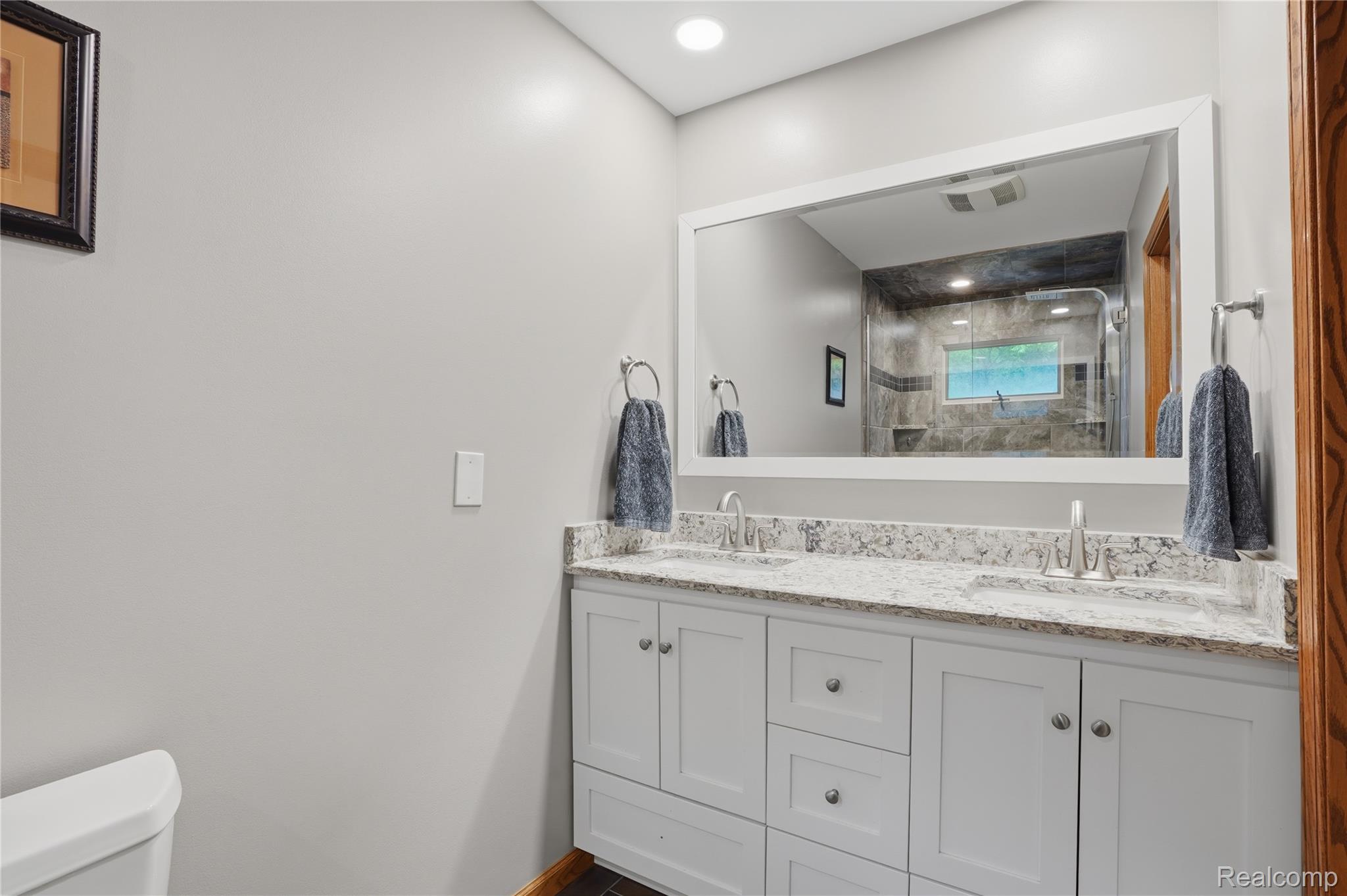 68345 Romeo Plank Road Ray, MI 48096 - Photo 36 of 52 Dual vanity with white cabinetry, light-toned countertop, and undermount sinks