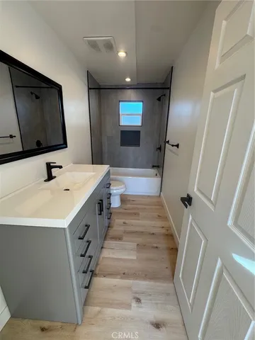 a bathroom with double vanity sink and mirror