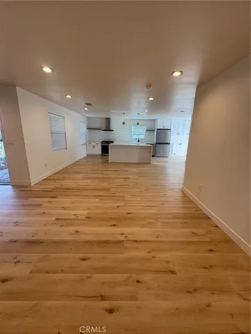 a view of kitchen and empty room