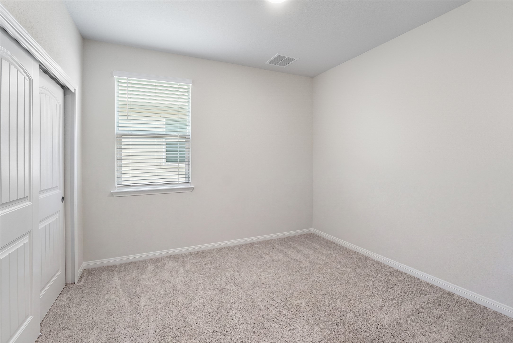 217 Evergreen Sumac Loop Kyle, TX 78640 - Photo 16 of 20 Well-lit room, perfect for a peaceful retreat, features soft carpet and a window for natural light.