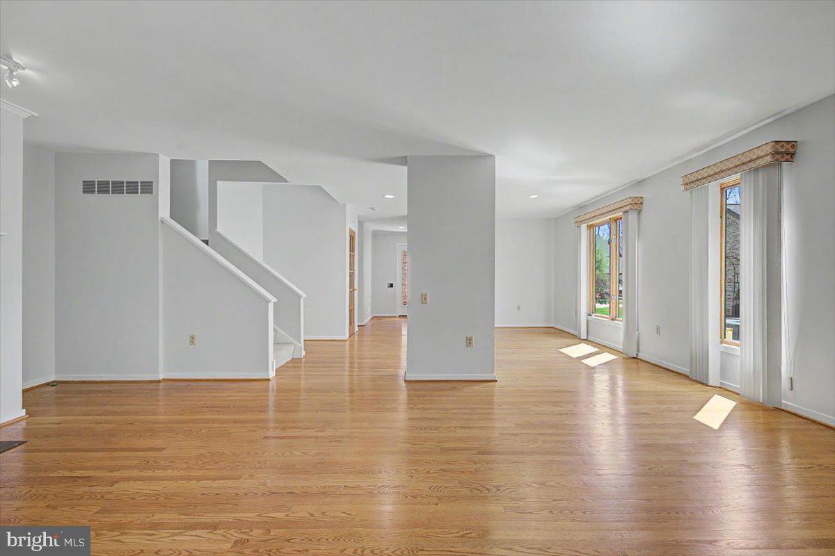 5 Steeplechase Road Wilmington, DE 19808 - Photo 11 of 39 a view of an empty room with wooden floor and a window