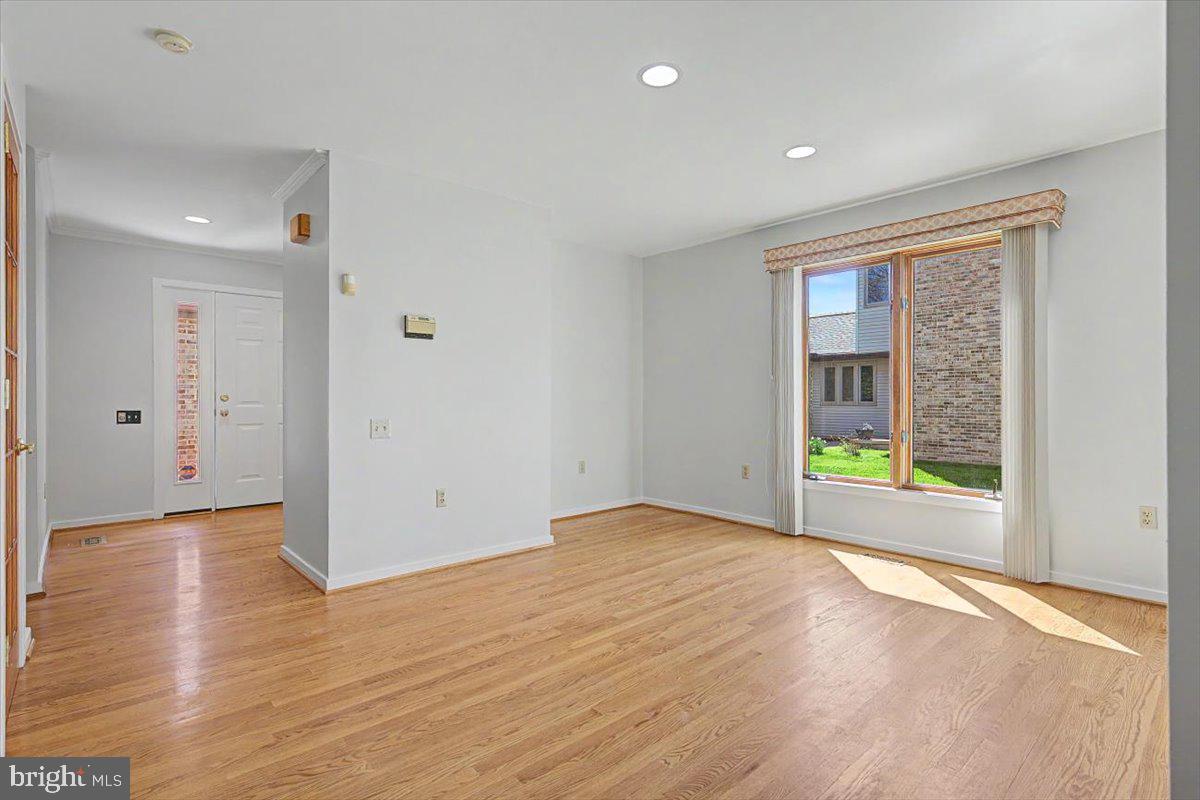 5 Steeplechase Road Wilmington, DE 19808 - Photo 12 of 39 a view of an empty room with wooden floor and a window