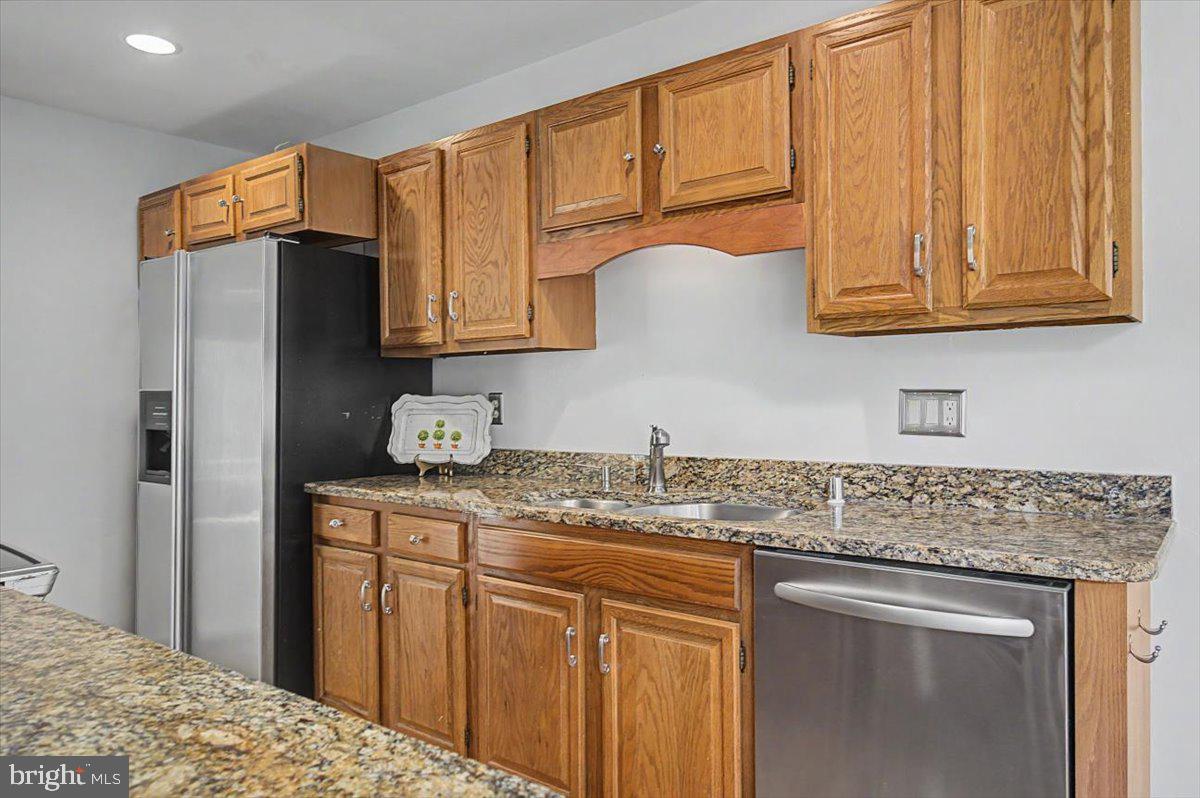 5 Steeplechase Road Wilmington, DE 19808 - Photo 14 of 39 a kitchen with stainless steel appliances granite countertop a sink stove and refrigerator