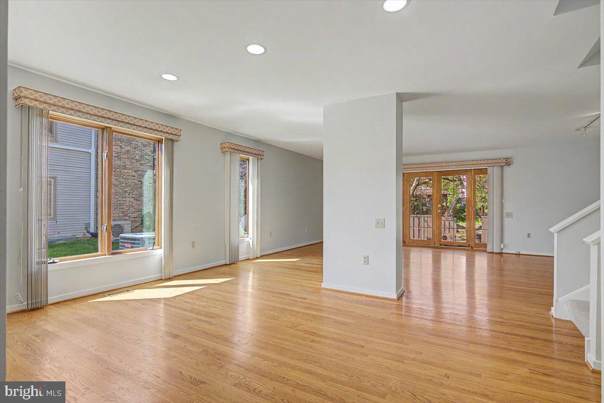 5 Steeplechase Road Wilmington, DE 19808 - Photo 7 of 39 a view of an empty room with wooden floor and a window