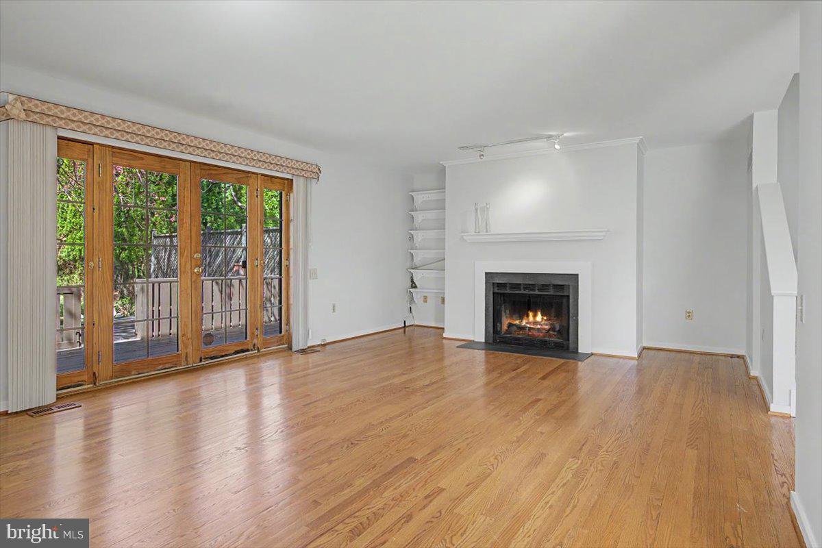 5 Steeplechase Road Wilmington, DE 19808 - Photo 10 of 39 a view of an empty room with wooden floor and a window