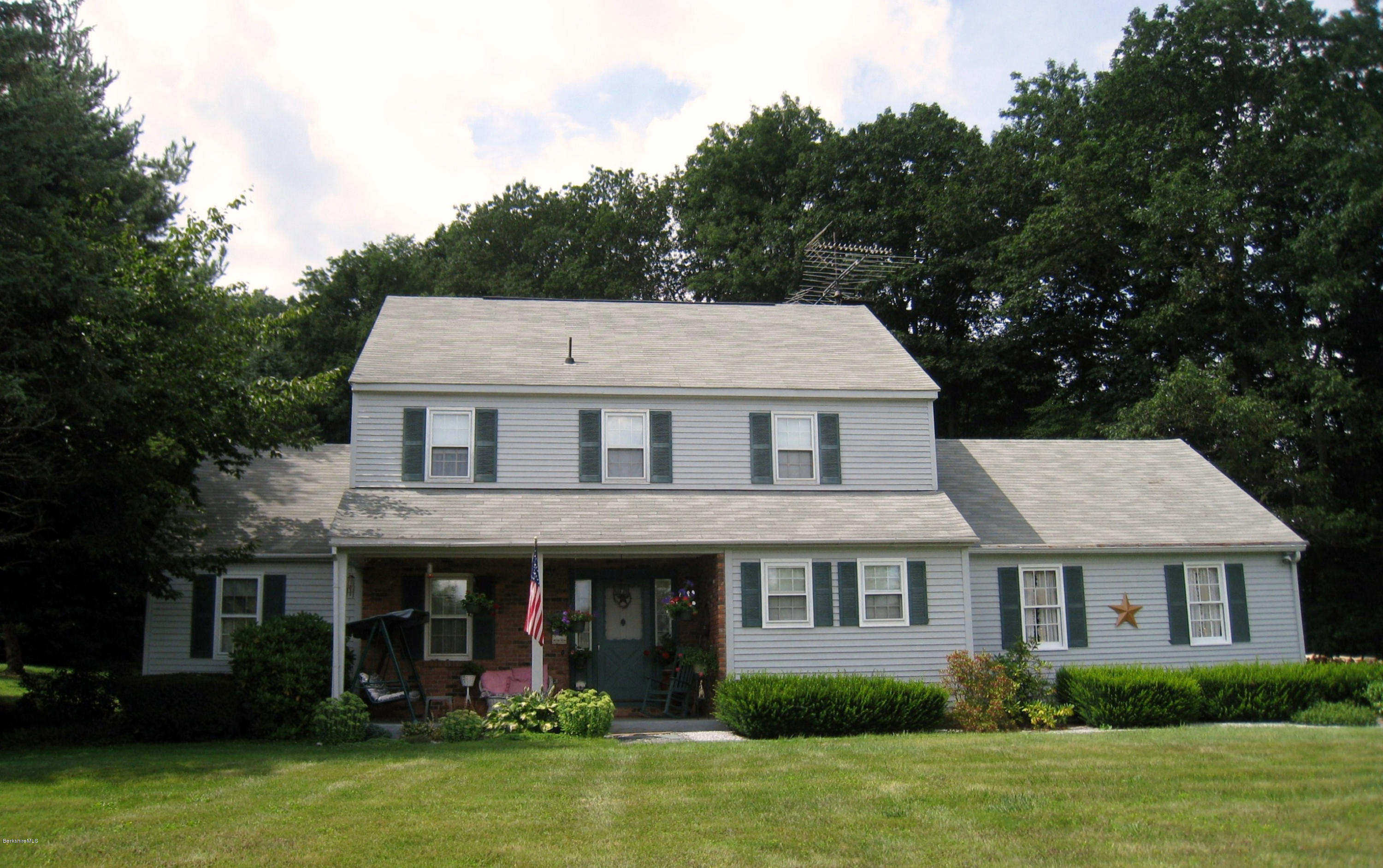 151 Old Post Road Richmond, MA 01201 - Photo 1 of 39 a aerial view of a brick house with a yard potted plants and a table