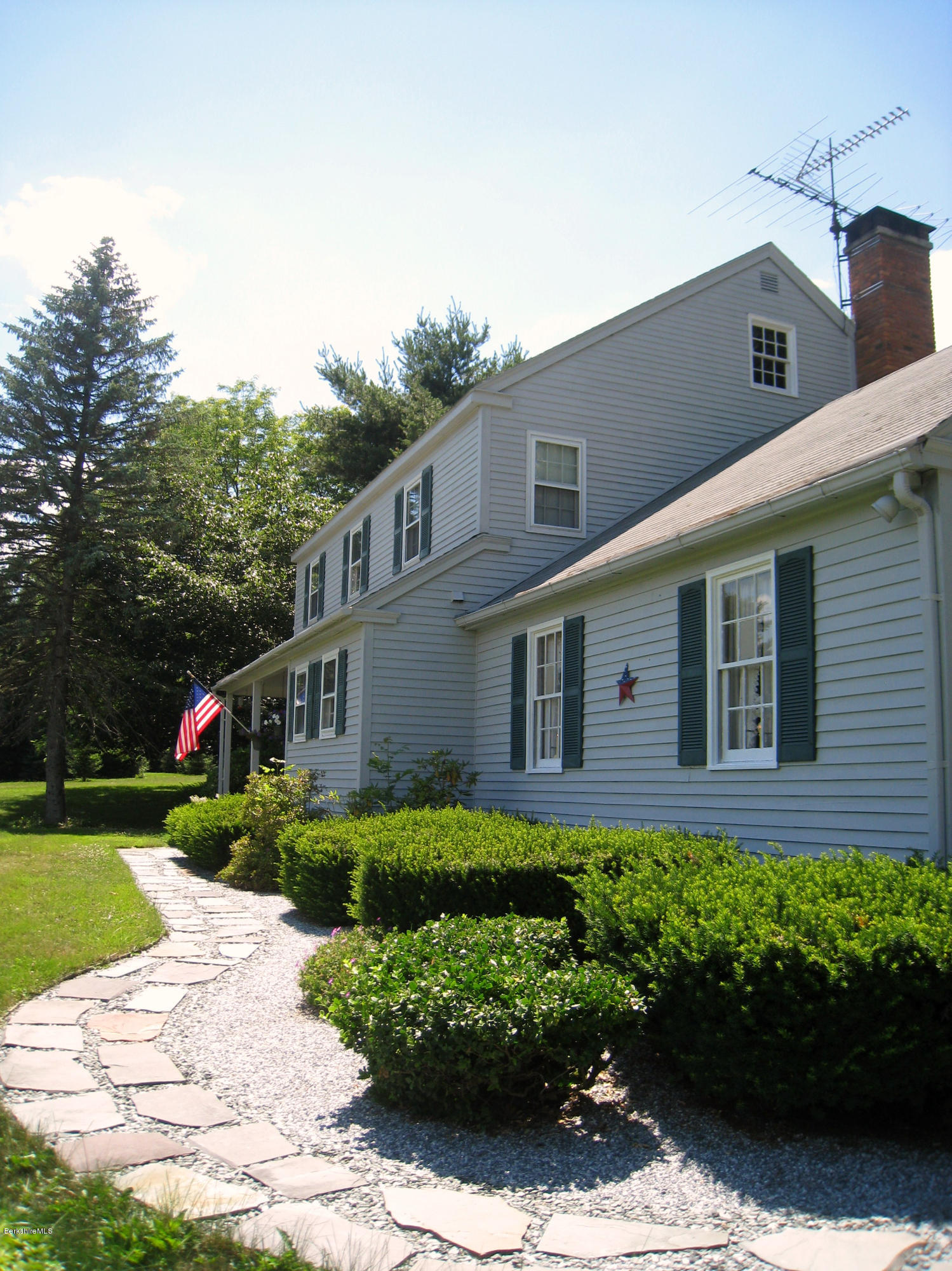 151 Old Post Road Richmond, MA 01201 - Photo 11 of 39 a front view of a house with a yard and garage