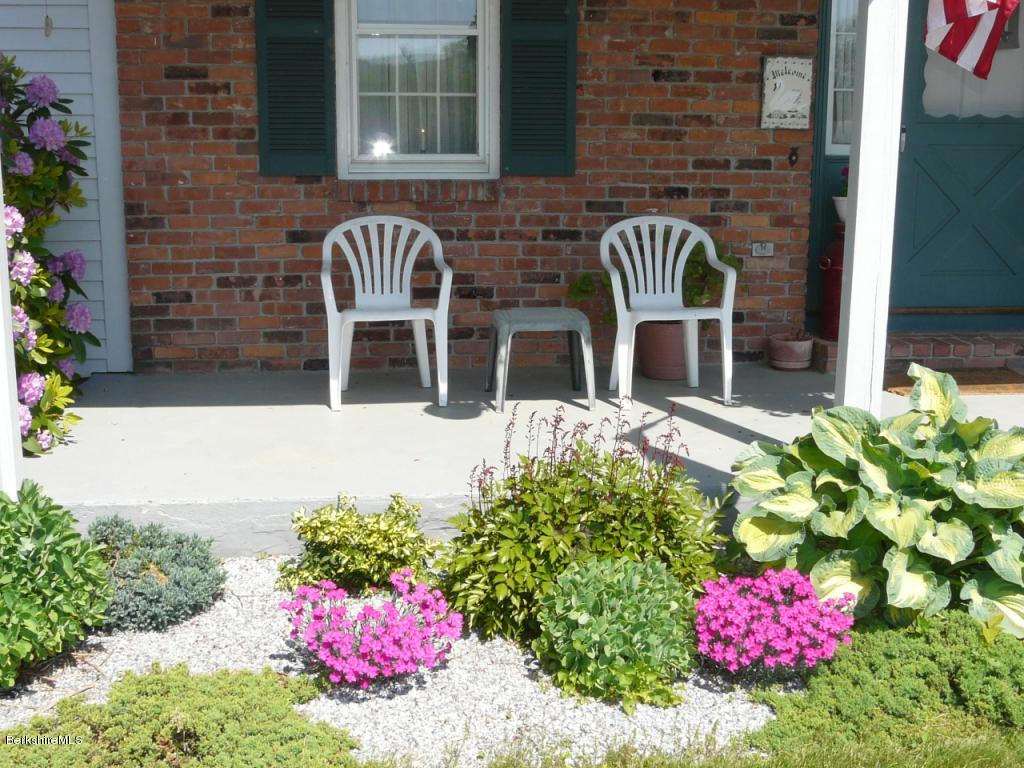 151 Old Post Road Richmond, MA 01201 - Photo 20 of 39 a front view of a house with outdoor seating