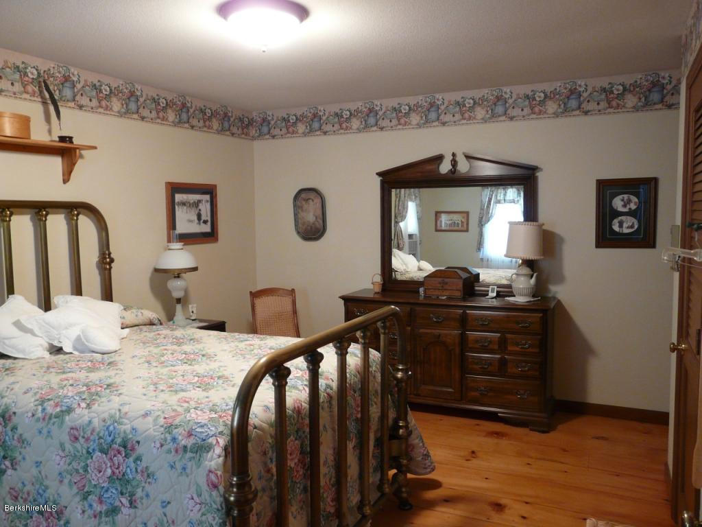 151 Old Post Road Richmond, MA 01201 - Photo 21 of 39 a bedroom with furniture and wooden floor