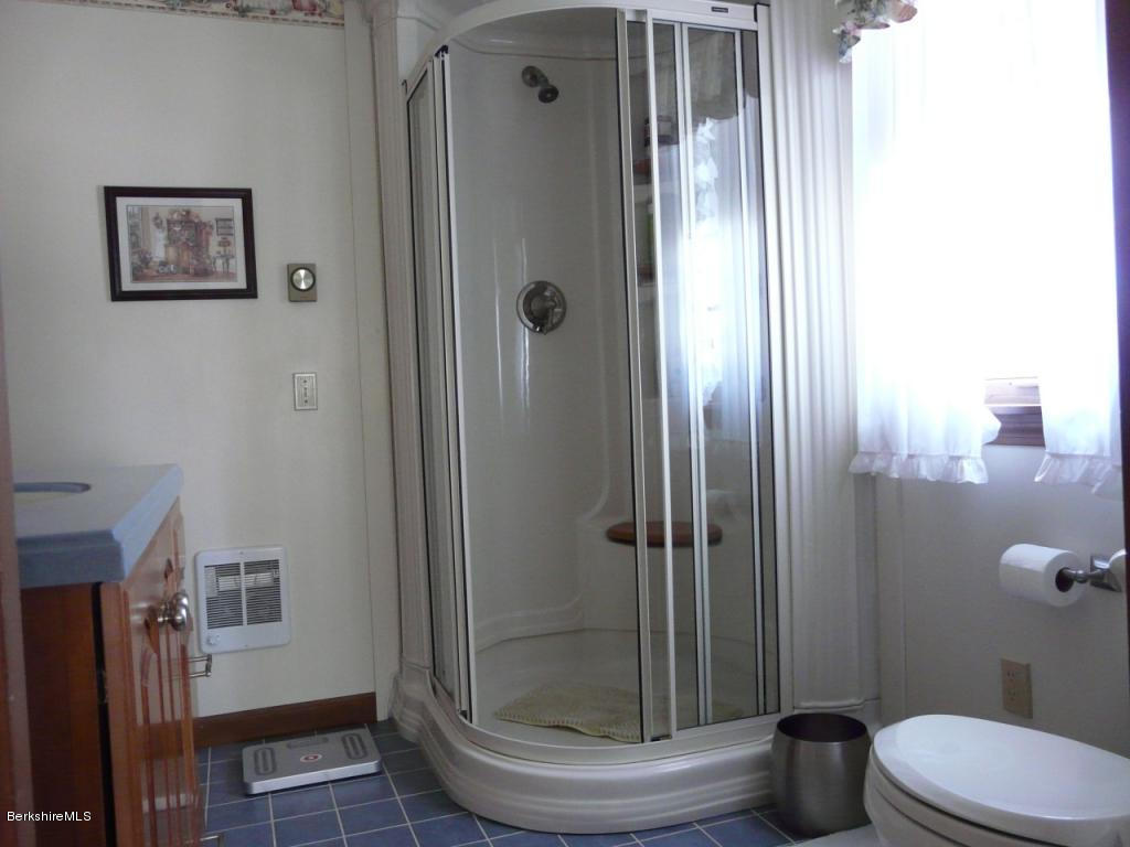 151 Old Post Road Richmond, MA 01201 - Photo 22 of 39 a bathroom with a glass shower door