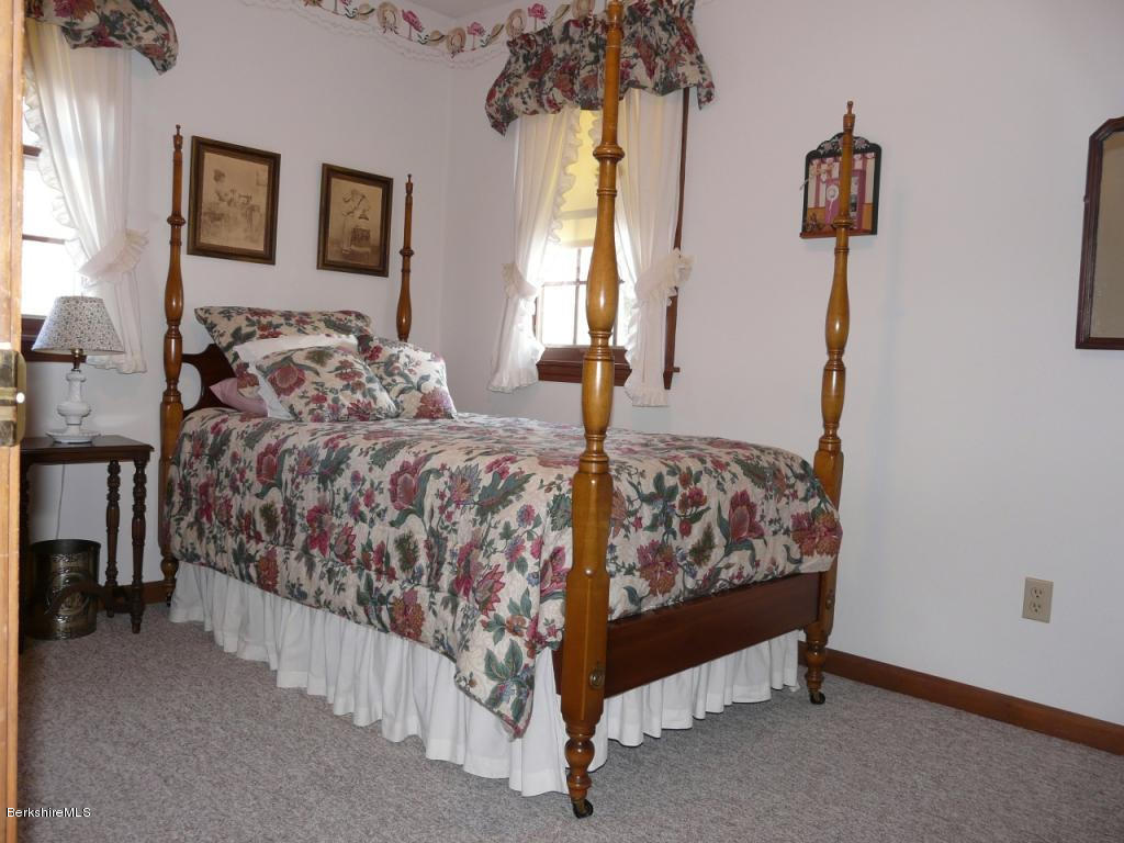 151 Old Post Road Richmond, MA 01201 - Photo 24 of 39 a bed sitting in a bedroom next to a window and lamp