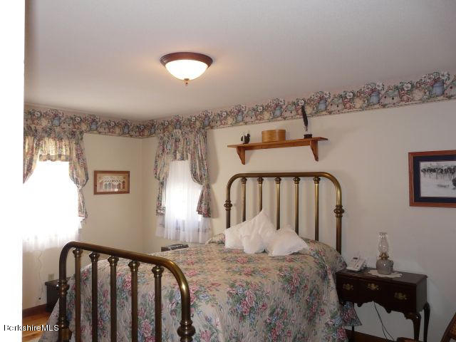 151 Old Post Road Richmond, MA 01201 - Photo 5 of 39 a view of a bedroom with furniture and staircase