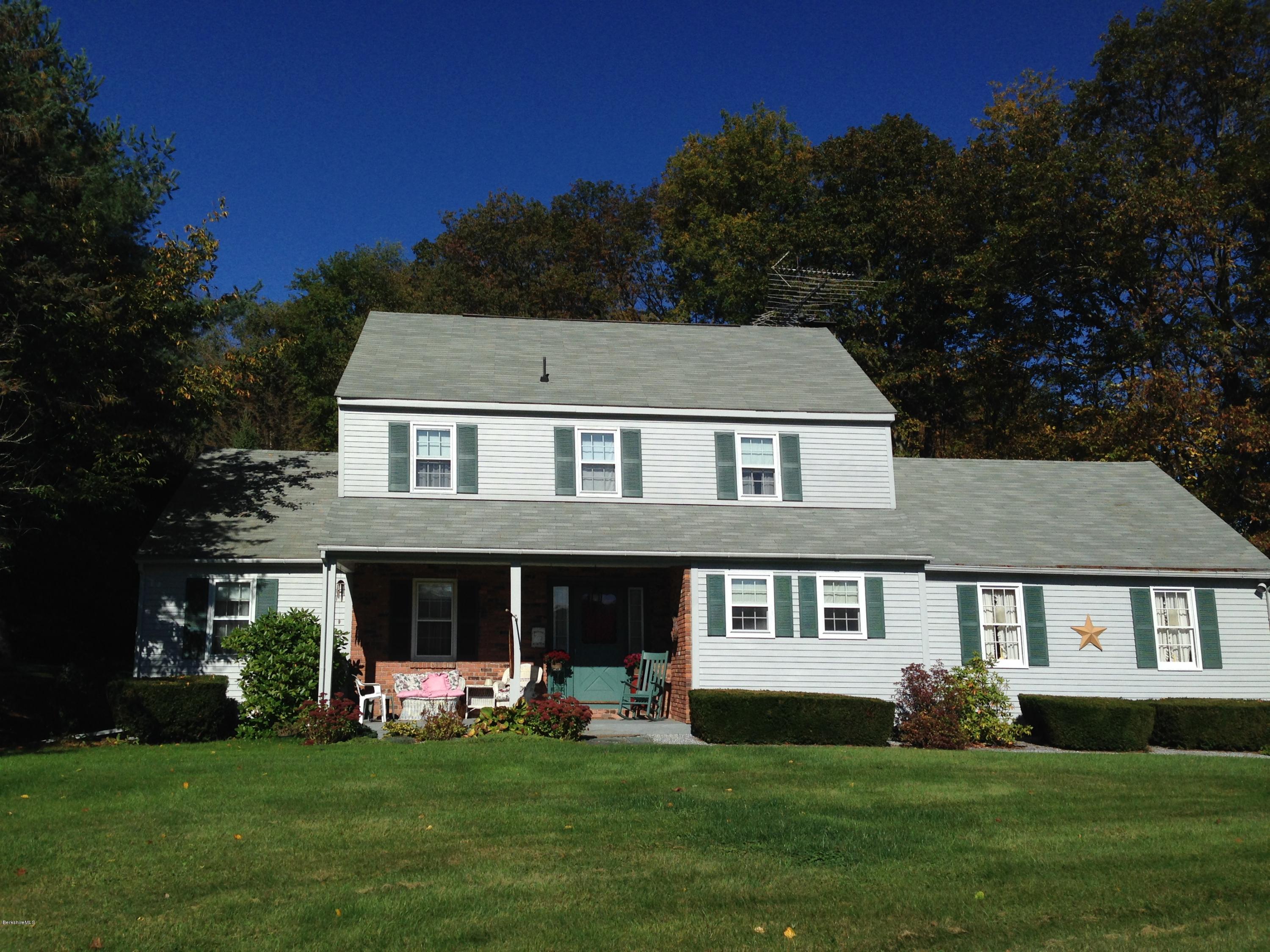 151 Old Post Road Richmond, MA 01201 - Photo 10 of 39 a front view of a house with a garden and porch