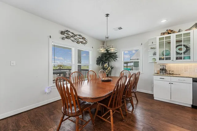 a large kitchen with a table and chairs