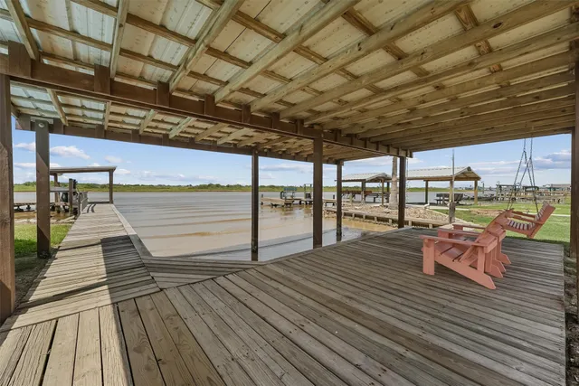 a view of a balcony with wooden floor and lake view