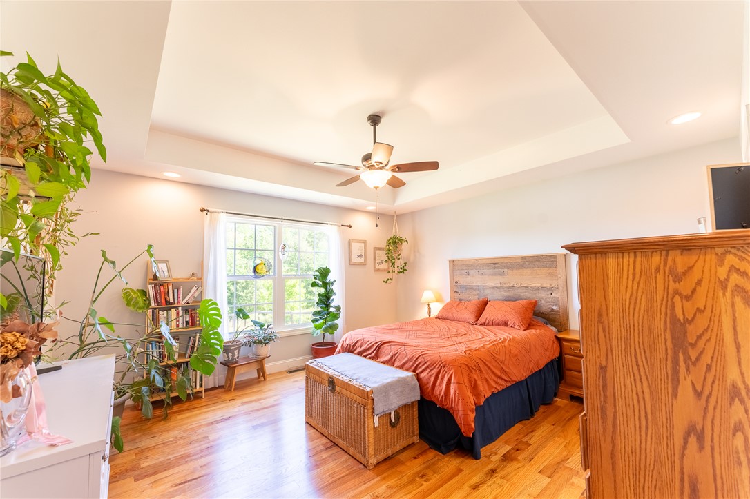 696 Mt Olivet Road Six Mile, SC 29682 - Photo 10 of 35 This spacious bedroom features warm hardwood floors and a striking tray ceiling.
