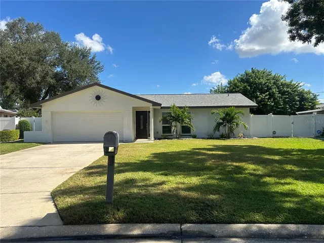 a view of a house with pool and a yard