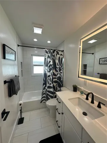 a bathroom with a double vanity sink a mirror and shower