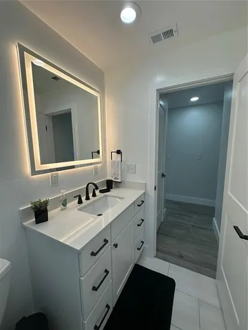 a bathroom with a double vanity sink mirror and shower