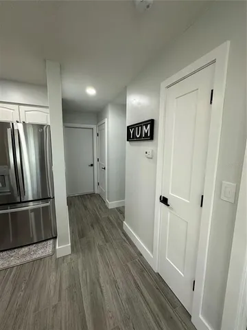 a view of a refrigerator in kitchen and wooden floor